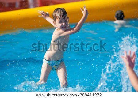 MOSCOW - JULY 26: Unidentified boy age 6-8 years plays in the pool during Moscow City Games in Luzhniki on July 26, 2014 in Moscow.