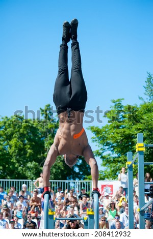 MOSCOW - JULY 26: Unidentified athlete performs during the street workout championship at Moscow City Games in Luzhniki on July 26, 2014 in Moscow.
