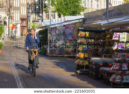AMSTERDAM - AUGUST 29: Unidentified man rides a bike to work in the morning on August 29, 2014 in Amsterdam.