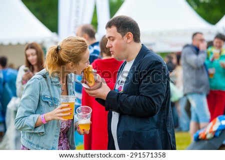 MOSCOW - JUNE 20, 2015: Young couple drink beer on XII International Jazz Festival \
