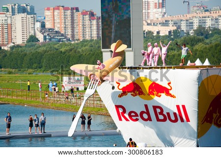 MOSCOW - JULY 26: Competitors perform a flight on Red Bull Flugtag on July 26, 2015 in Moscow. Red Bull Flugtag is an event in which competitors attempt to fly homemade human-powered flying machines