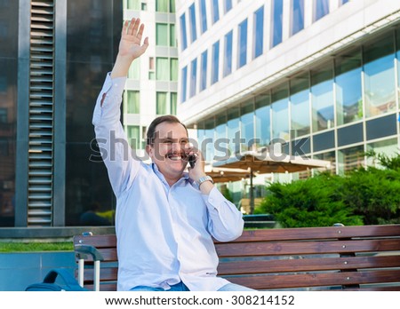 Businessman waving a hand to someone. He is glad to meet