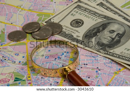 Objects for planning travel - a map, a magnifier, money