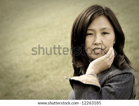 Aged style portrait of young attractive woman outdoors. You can use left part as copyspace.