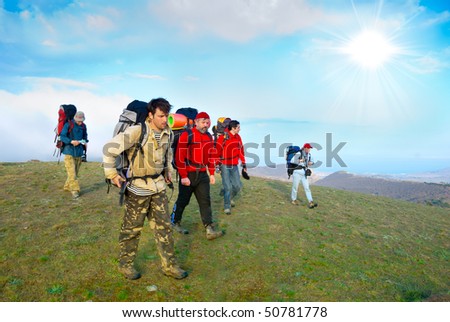 Hikers group walking in spring mountains