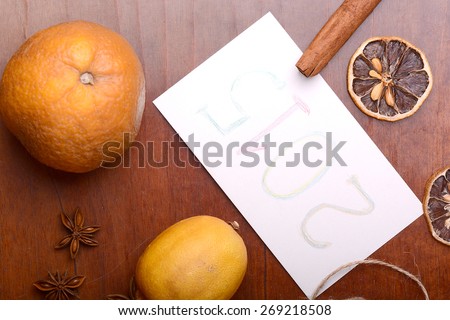 lemon and cinnamon, old fruits and anise on wooden plate
