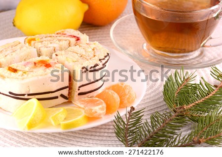 tea coffee cup, sweet cake on white plate and fruits, lemon mandarin slices
