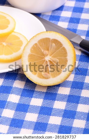 Fresh juicy sliced lemon on a ceramic plate.