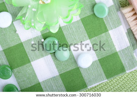 spa settings, green towel with white and green spa stone, hairbrush