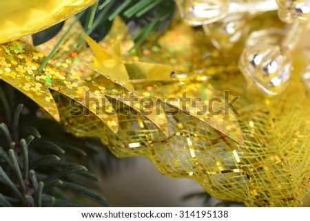 Image of Christmas tree branch with golden material, festive border, New Year greeting card, magic night, glowing backdrop, xmas decoration, holiday ornament
