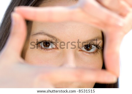 Portrait of young woman creates a frame with her hands. Isolated on white background