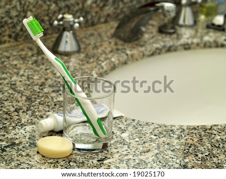 Toothpaste, toothbrush and soap on bathroom worktop