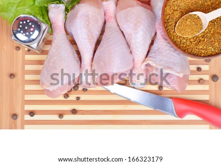 Fresh chicken legs on cutting board