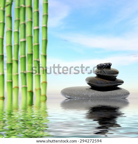Zen spa concept background-Zen massage stones and bamboo reflected in water
