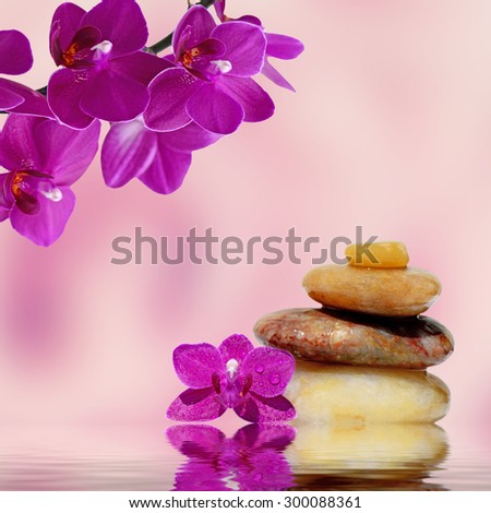 Zen spa concept background-Zen massage stones and orchid flowers reflected in water