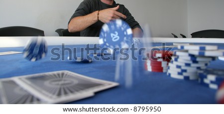 A poker player throws a handful of chips onto the table to place a bet