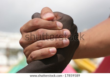 A black and a white person shake hands