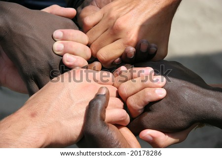 Black and white hands joined together