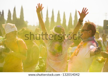 LOS ANGELES - MARCH 16 : Man with arms raised in free spirited dance motion. Holi Festival of Colors on March 16, 2013 in Los Angeles, CA