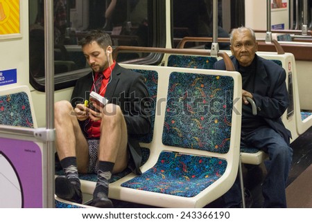 Los Angeles, CA - January 11, 2015: A man without pants reading a book during the 7th Annual International \
