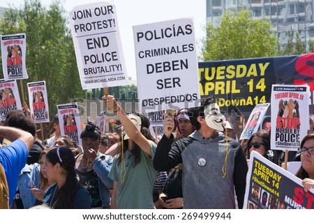 Los Angeles, CA, USA - April 14, 2015:  Man wearing mask holding a sign and blowing a whistle during Stop Murder by Police. Protest against the brutalization and murdering of black and latino people.