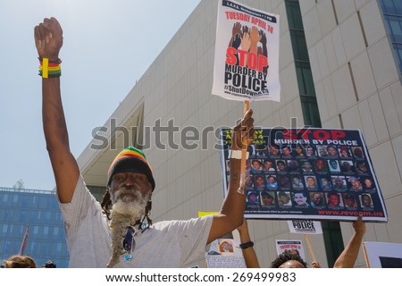 Los Angeles, CA, USA - April 14, 2015:  Man raising hand for justice during Stop Murder by Police.