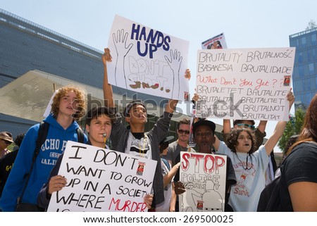 Los Angeles, CA, USA - April 14, 2015:  Group of people holding signs and blowing whistles during Stop Murder by Police.