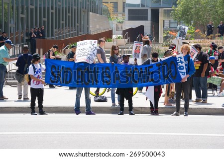 Los Angeles, CA, USA - April 14, 2015:Kids holding banner during Stop Murder by Police. Protest against the brutalization and murdering of black and latino people by police without consequence.