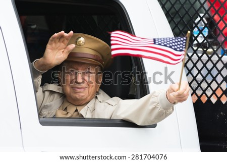 Canoga Park, CA, USA - May 25, 2015: US veteran holding americam flag during Memorial Day Parade