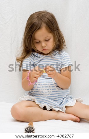 the little cute girl brushing her hair