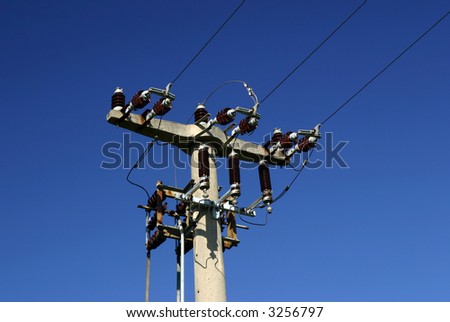 The Top of an old power pole in deep blue sky.