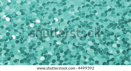 Turquoise confetti glitter background (selective focus)