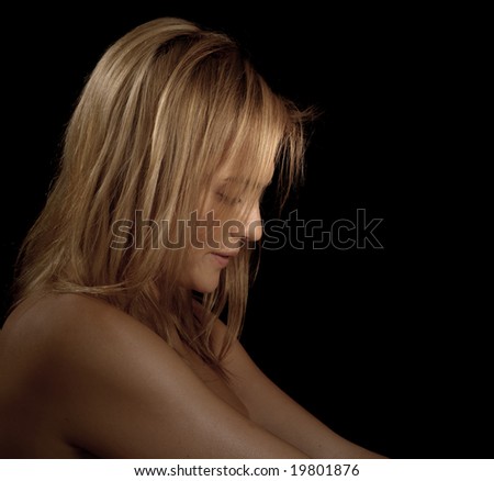 Glamour portrait of a woman looking down on black