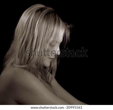 Glamour portrait of a woman down on black