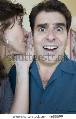 Woman whispers in his ear and he is surprised
