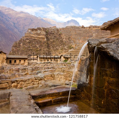 Ollantaytambo - A fountain, part of the Inca domestic water supply, Inca ruins in the background