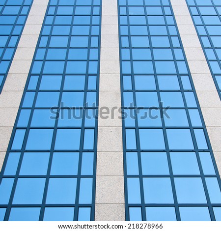 blue sky reflected in grid formed by windows
