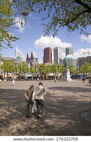 The Hague, Netherlands, 6 may 2015: elderly couple walk on Plein in dutch town of The hague on spring day
