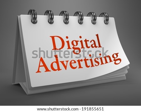 Digital Advertising - Red Inscription on a Desktop Calendar Isolated on Gray Background.
