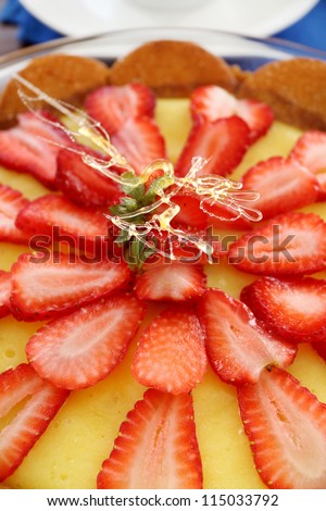 Lovely strawberry custard biscuit tart with toffee garnish ready to serve.