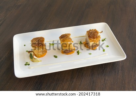 Delicious roasted pork belly cubes on baked pumpkin with fried apple chips and a cauliflower puree with oregano and sage.