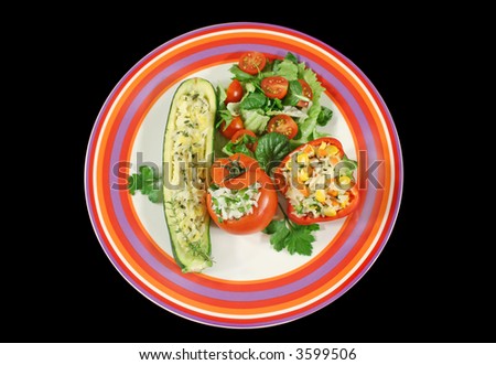 Delicious vegetable combination of stuffed zucchini, pepper and tomato with side salad.
