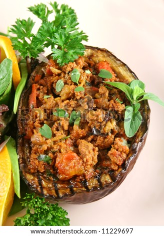 Egg plant stuffed with bolognaise with side salad and garnish.