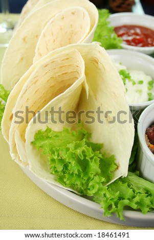 Mexican vegetarian platter with tortillas, sour cream and tomato salsa,