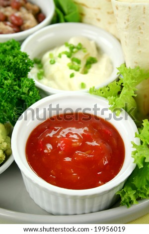 Mexican vegetarian platter with tortillas, sour cream and tomato salsa