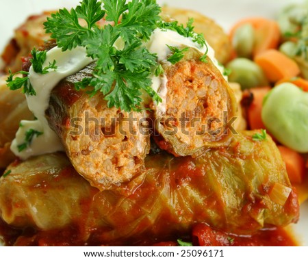 Baked cabbage rolls with carrots and broad beans with a tomato sauce.