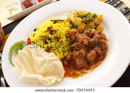 Delicious and spicy Indian beef curry served with pappadums.
