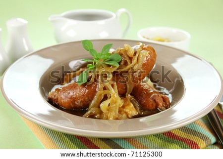 The classic English meal of bangers and mash with gravy ready to serve.