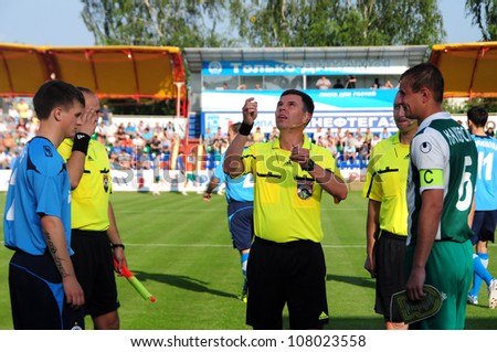 MINSK,BELARUS JUNE 19: Referee Igor Kruk tosses a coin during match between FC Dynamo and FC GOMEL on June 19, 2012 in Minsk, Belarus