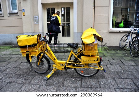 BERLIN MARCH 6: Postman on a bicycle (over 15% people in Berlin prefer moving by bike) on March 6, 2015.